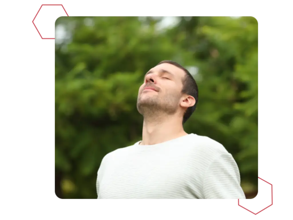 Man breathing deeply in the forrest